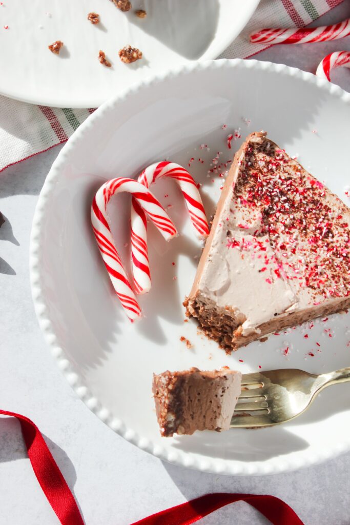 A picture of a plated piece of pie with a bite on a fork.