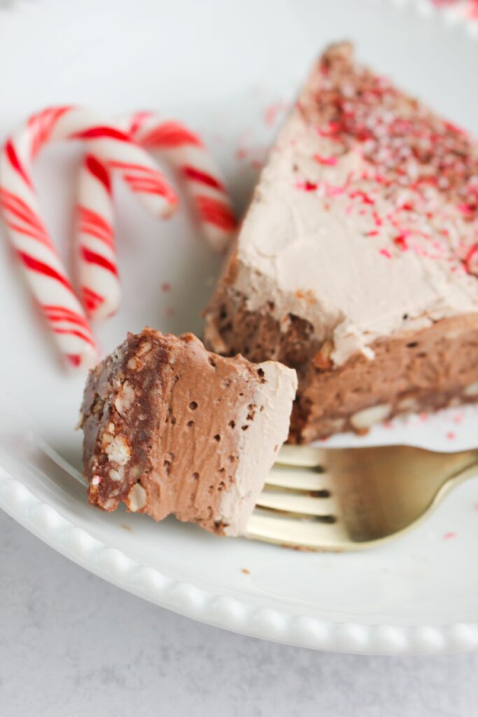 An upclose picture of a piece of pie on a fork.