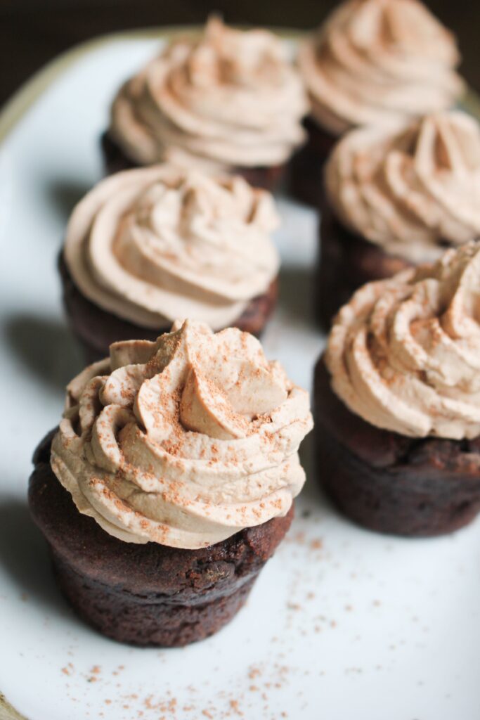 The frosting swirled onto mini chocolate cupcakes.