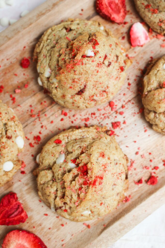 A strawberry and cream vegan valentines cookie on a platter ready to eat.