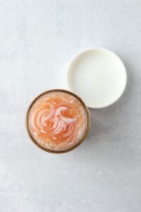 The pickled shallots in a mason jar.