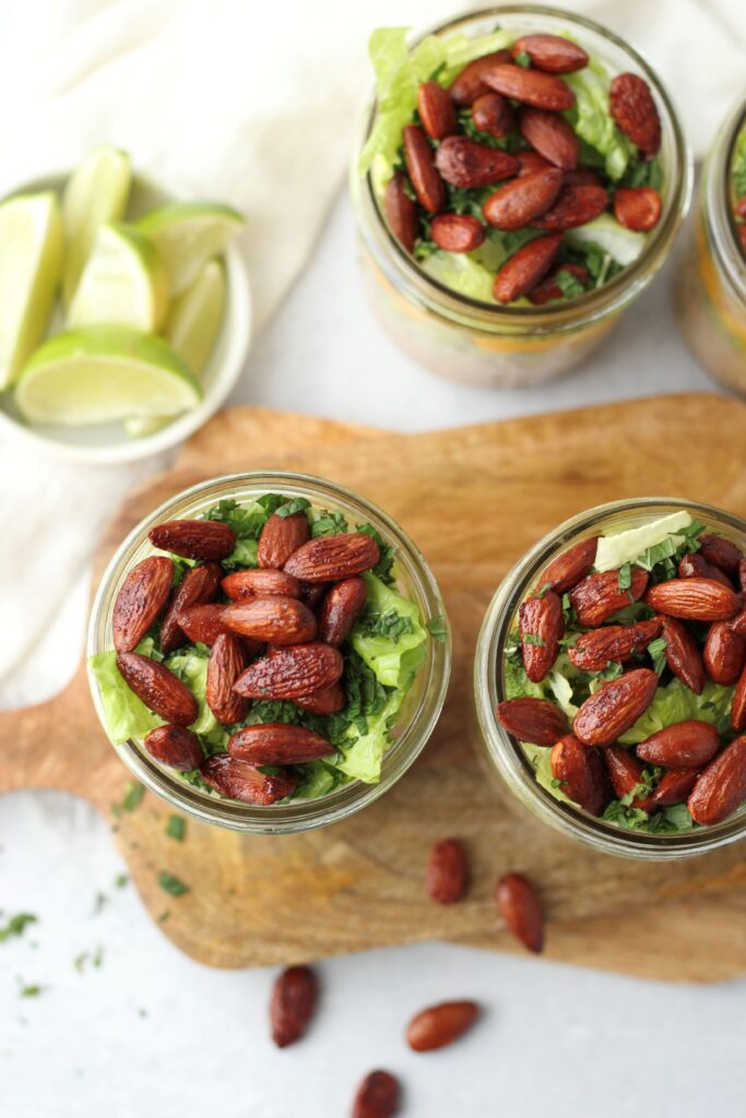 All four mason jars filled with this Thai-inspired salad.