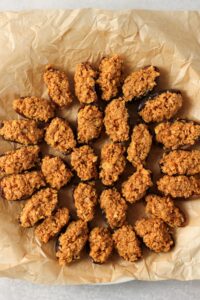 The dates have been stuffed with the peanut butter mixture and are on a plate.