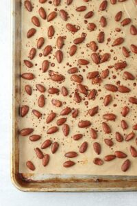 The almonds have been roasted on a pan.