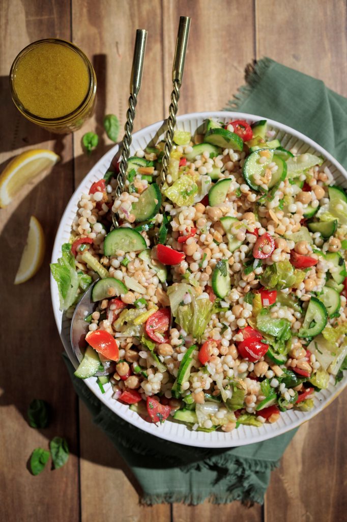 This Pearl Couscous Salad with Vegetables is in a bowl and is ready to eat.