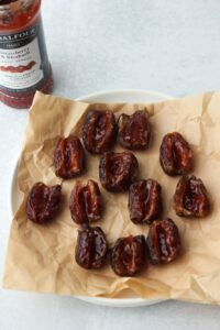 The dates have been filled with a teaspoon of strawberry jam.