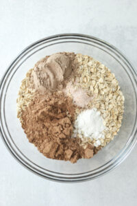 All of the dry ingredients in a glass bowl.