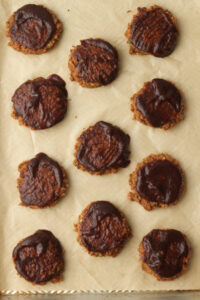 BBQ sauce has been added to the tops of the patties