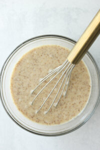 All of the wet ingredients in a glass bowl.