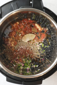 All of the ingredients in the pressure cooker bowl.
