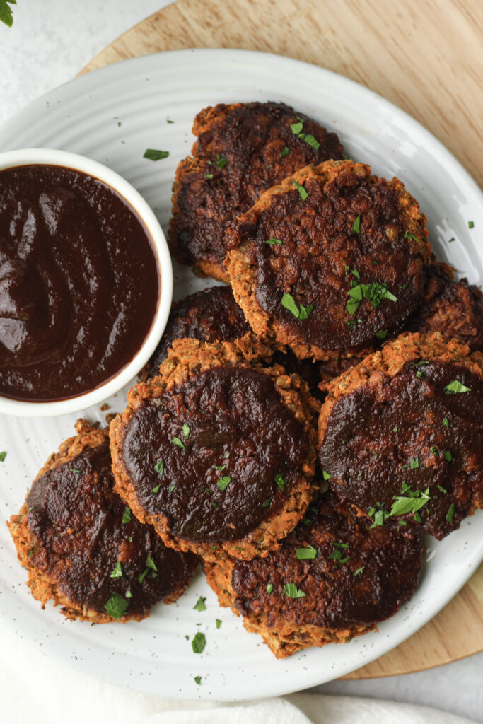 The vegan BBQ lentil patties are plated and ready to eat.