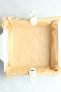 The parchment paper is placed onto the dish.