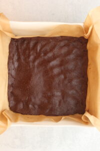 The chocolate layer has been pressed into the bottom of the dish in one even layer.
