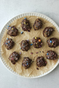 The dates have been drizzled with melted chocolate and topped with crushed chocolate candies.