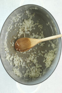 The onions and garlic are sautéing in a stockpot.