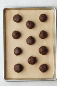 The balls have been rolled and placed onto a cookie sheet.