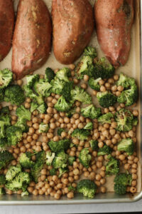 The broccoli and chickpea mixture has been added to the cookie sheet.