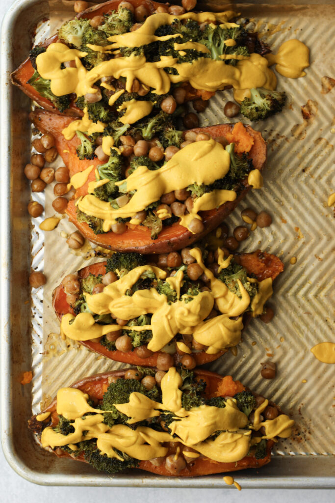 The stuffed sweet potatoes are on a cookie sheet and are ready to enjoy.