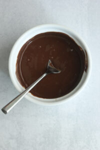 The chocolate and coconut oil have been melted in a small bowl.