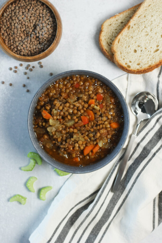 A bowl of warm soup was just served into a small bowl.