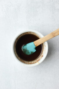 The glaze is in a small white mason jar and is ready to put over the muffins.