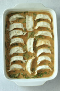 The dumplings have been added to the casserole dish in columns. 