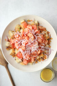 All of the salad ingredients have been added to a large bowl and need to be tossed.