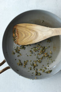 Sautรฉing garlic and fresh rosemary in a small saucepan.