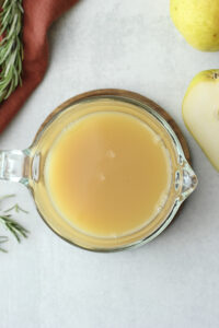 The pear juice mixture is in a small pitcher and is ready to chill in the fridge.