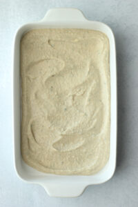 The white bean puree spread into a dish.