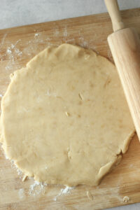 The dough has been rolled out on a cutting board.