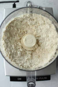 The dry ingredients have been blended in the food processor for the crust.