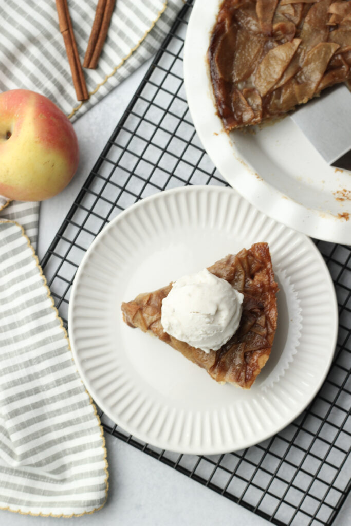 A slice of apple pie with a scoop of ice cream.