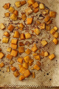 The squash is finished roasting on a baking pan.