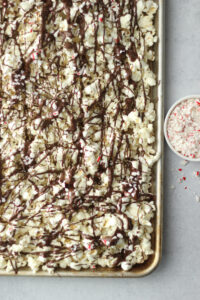 The crushed candy cane has been sprinkled over the drizzled chocolate.