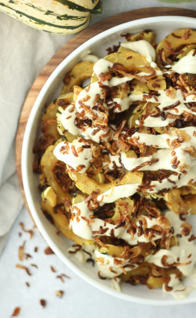 Roasted delicata squash topped with crispy onions.