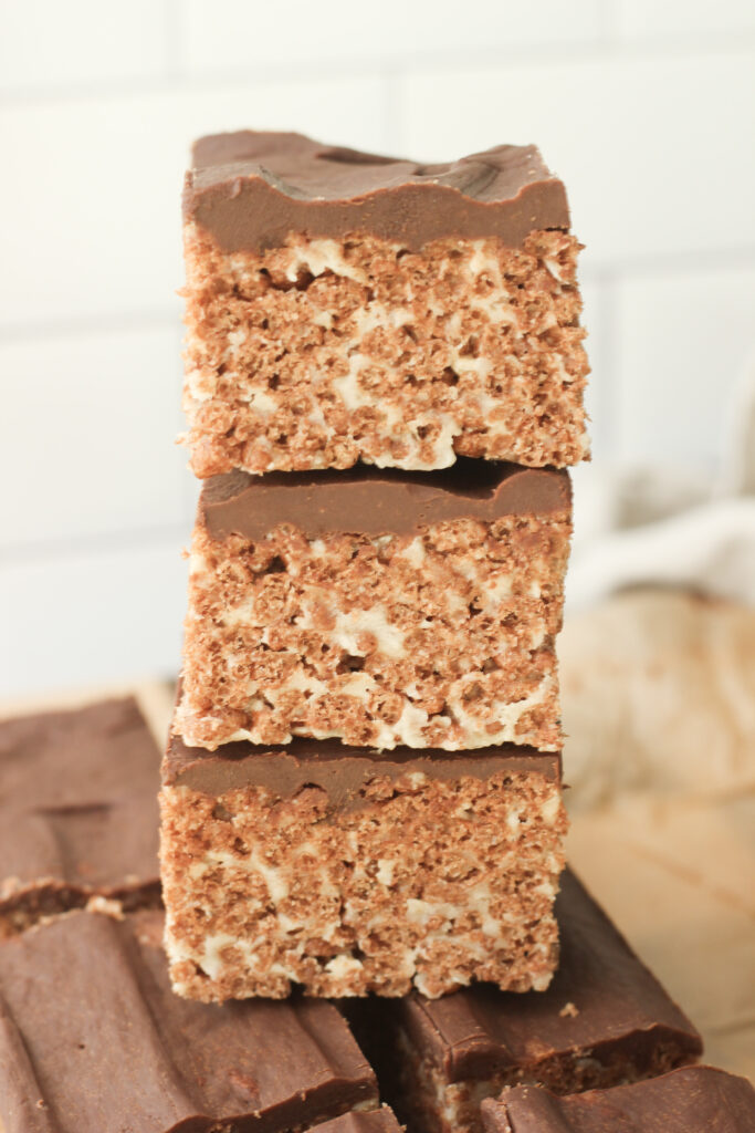 Three rice krispie treats are stacked on top of each other.