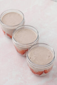 The mixture has been evenly poured into three mason jars.