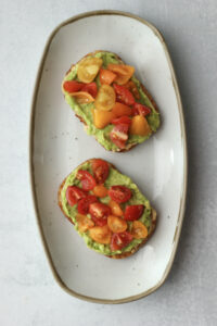Cherry tomatoes were sprinkled over the avocado.