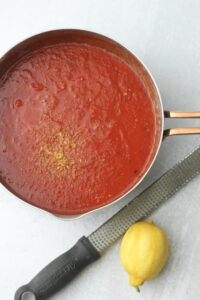 The lemon zest has been added to the marinara sauce.