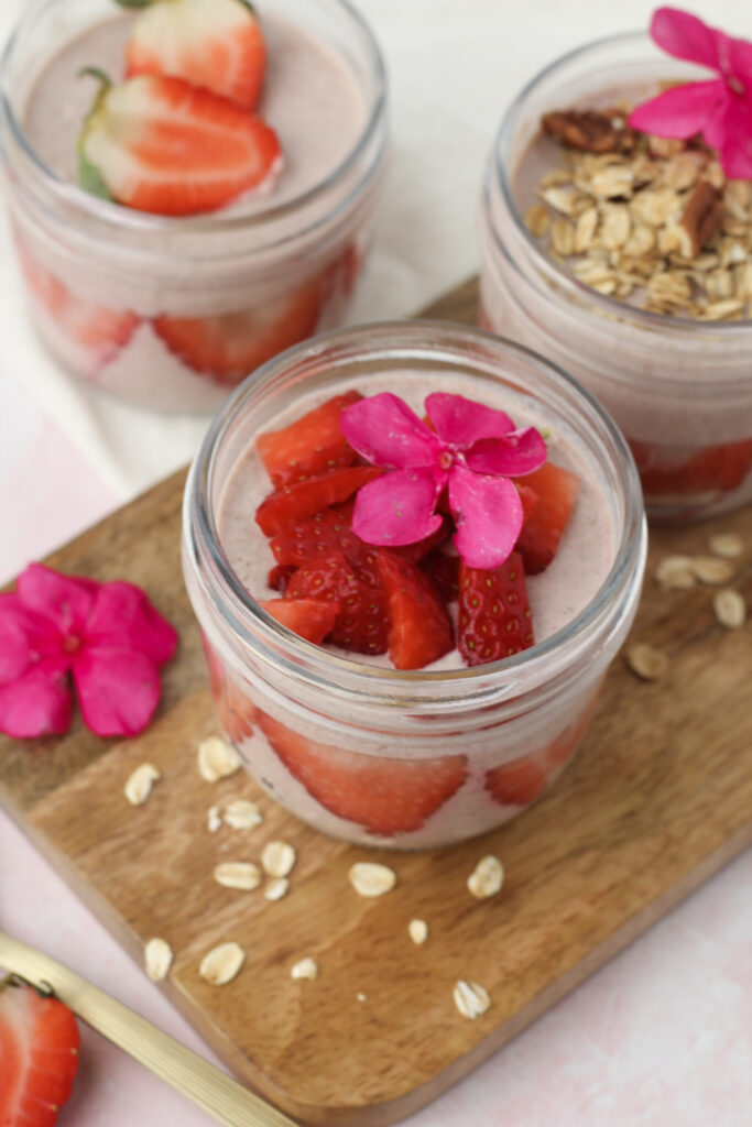 The overnight oats are topped with chopped strawberries and are ready to enjoy.