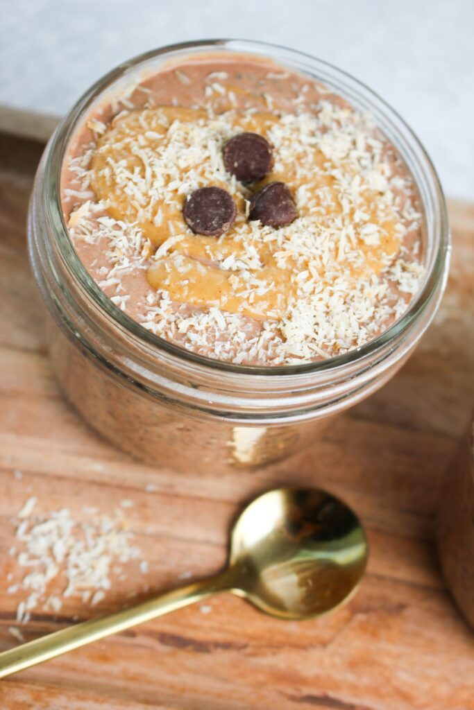 One chocolate peanut butter chia seed pudding in a mason jar is ready to eat.