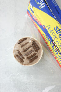 Added plastic wrap to the yogurt cup and then placing it into the fridge.