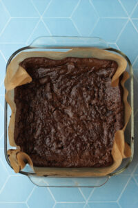 The brownies have been baked in the oven in an 8x8 pan.