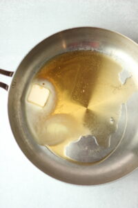 The butter has been melted in a frying pan.