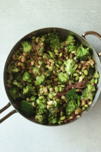 The cashews and edamame have been added to the pan.