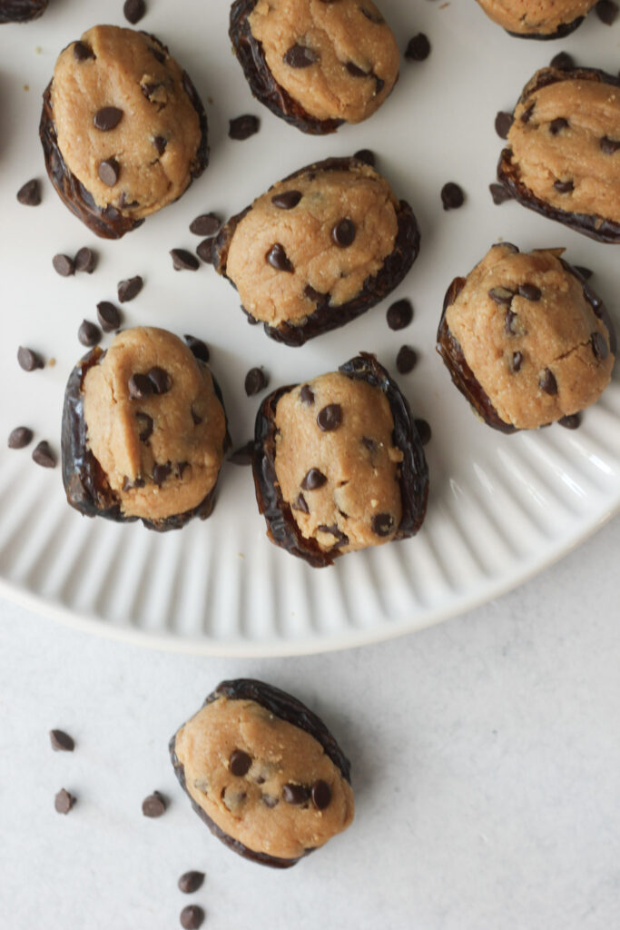 The finished peanut butter cookie dough dates on a white plate.