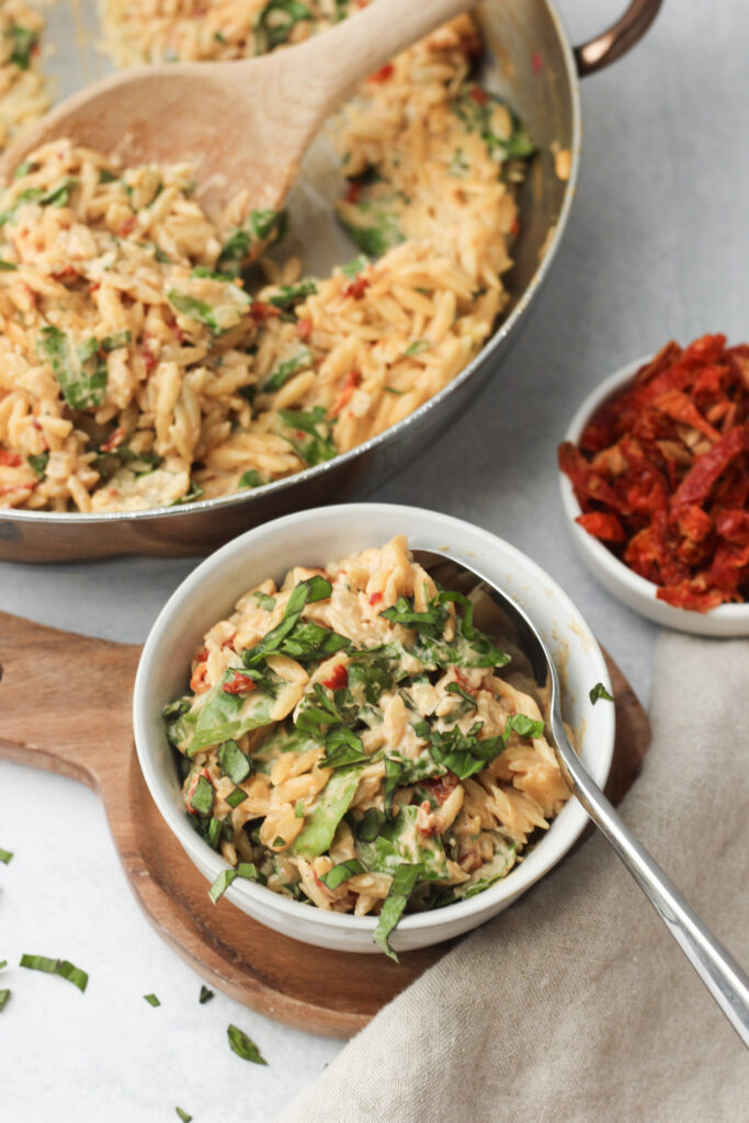 The orzo pasta has been served in a small white bowl.