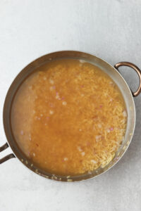 The vegetable stock has been added to the pan.
