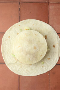 A small tortilla has been added to the top of the ingredients.